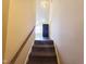 Carpeted stairs lead to the upper level, offering a view into the kitchen with natural light at 650 Ganyard Farm Way # 41, Durham, NC 27703