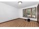 Bright bedroom features wood-look flooring, a large window, and neutral walls at 6516 Hearthstone Dr # 6516, Raleigh, NC 27615