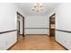 Spacious dining room with wood-look floors and an elegant chandelier offers views into adjacent rooms at 6516 Hearthstone Dr # 6516, Raleigh, NC 27615