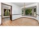 Bright dining room featuring elegant chandelier, wood-look floors, and large windows with outdoor views at 6516 Hearthstone Dr # 6516, Raleigh, NC 27615