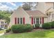 A well-maintained home with neat landscaping is accented by striking red shutters on the front windows at 6516 Hearthstone Dr # 6516, Raleigh, NC 27615