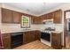 A full kitchen featuring wooden cabinets, laminate countertops, and a black dishwasher at 6516 Hearthstone Dr # 6516, Raleigh, NC 27615