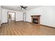 Inviting living room with a brick fireplace, doorway view, and stylish wood-look floors at 6516 Hearthstone Dr # 6516, Raleigh, NC 27615