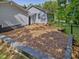 Backyard features professionally landscaped yard and exterior wall at 707 Lakewood Dr, Siler City, NC 27344