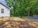 Large, fenced backyard featuring a fire pit area, perfect for outdoor gatherings and relaxation at 707 Lakewood Dr, Siler City, NC 27344