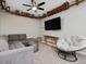 Finished basement with modern ceiling fan, gray couch and unique wooden ceiling fixtures at 707 Lakewood Dr, Siler City, NC 27344