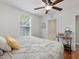 Comfortable bedroom with hardwood floors, natural light, and a workspace area at 707 Lakewood Dr, Siler City, NC 27344