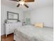 Bright bedroom with hardwood floors, decorative mirror, and a comfortable bed at 707 Lakewood Dr, Siler City, NC 27344