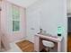 Charming bedroom featuring a pink desk, natural light, and hardwood floors at 707 Lakewood Dr, Siler City, NC 27344