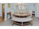 Dining room featuring a round table with upholstered chairs and a bench under a chandelier at 707 Lakewood Dr, Siler City, NC 27344