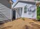 Backyard exterior of home with blue siding, a door, and low-maintenance landscaping at 707 Lakewood Dr, Siler City, NC 27344