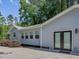 Charming home exterior with light blue siding, well-manicured landscaping and concrete patio at 707 Lakewood Dr, Siler City, NC 27344