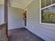 Covered front porch featuring a window, wreath, and exterior in light blue at 707 Lakewood Dr, Siler City, NC 27344