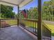 Cozy front porch with a railing and an American flag waving in the breeze at 707 Lakewood Dr, Siler City, NC 27344