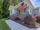 Front porch with brick base, railing and American flag. The exterior is light blue at 707 Lakewood Dr, Siler City, NC 27344