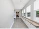 Bright hallway with tiled floor, built-in cabinets, and multiple windows at 707 Lakewood Dr, Siler City, NC 27344
