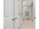 Hallway featuring multiple closets and access to the bathroom with neutral tile flooring at 707 Lakewood Dr, Siler City, NC 27344