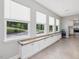 Hallway featuring three windows with built-in storage and a tiled floor at 707 Lakewood Dr, Siler City, NC 27344
