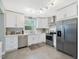 Well-lit kitchen with stainless steel appliances, ample counter space, and stylish white cabinetry at 707 Lakewood Dr, Siler City, NC 27344