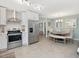 Modern eat-in kitchen features stainless steel appliances, white cabinetry, and tile backsplash at 707 Lakewood Dr, Siler City, NC 27344