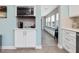 Charming kitchenette with modern microwave, white cabinets, and views of the dining area at 707 Lakewood Dr, Siler City, NC 27344