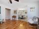 Hardwood floors lead into a dining room with upholstered chairs, a round table, and chandelier at 707 Lakewood Dr, Siler City, NC 27344