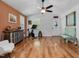 Cozy living room showcasing hardwood floors, access to the foyer and exercise equipment at 707 Lakewood Dr, Siler City, NC 27344