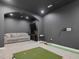 Recreation room features golf simulator, projector screen, sitting area, and TV at 707 Lakewood Dr, Siler City, NC 27344