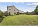 Beautiful backyard features a well-manicured lawn, a stone patio, and a fenced perimeter at 817 Ember Dr, Durham, NC 27703