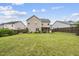 Large backyard featuring a well-maintained lawn and a covered patio area for outdoor entertaining at 817 Ember Dr, Durham, NC 27703