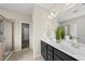 Modern bathroom features a double sink vanity, a glass-enclosed shower, and tile flooring at 817 Ember Dr, Durham, NC 27703