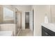 Bright bathroom featuring a glass shower, tile floors, modern fixtures, and a neutral color palette at 817 Ember Dr, Durham, NC 27703