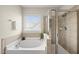 Bathroom features a soaking tub, a tiled glass shower, and a window providing natural light at 817 Ember Dr, Durham, NC 27703