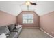Cozy bedroom features a vaulted ceiling, plush carpet, a gray couch, and a window that provides natural light at 817 Ember Dr, Durham, NC 27703