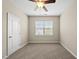 Empty bedroom with neutral walls, carpet flooring, a ceiling fan, and a large window at 817 Ember Dr, Durham, NC 27703