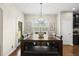Eat-in kitchen dining area with wood floors features a table with seating and a door leading to the backyard at 817 Ember Dr, Durham, NC 27703