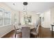 Dining area features hardwood floors, modern lighting, a round table, and lots of natural light at 817 Ember Dr, Durham, NC 27703