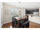 Eat-in kitchen dining area features a wooden table with seating, stylish chandelier, and large window at 817 Ember Dr, Durham, NC 27703