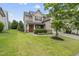 Charming two-story home with a manicured lawn and a welcoming front porch with orange door at 817 Ember Dr, Durham, NC 27703