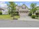 Charming two-story home with a two car garage, well maintained lawn, and mature trees at 817 Ember Dr, Durham, NC 27703