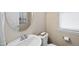Charming half bathroom featuring stylish fixtures, an oval mirror, and neutral wall color at 817 Ember Dr, Durham, NC 27703