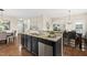 Open-concept kitchen offers modern appliances, granite countertops, and a large kitchen island at 817 Ember Dr, Durham, NC 27703