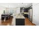 Modern kitchen features stainless steel appliances, granite countertops, and a view of the dining area at 817 Ember Dr, Durham, NC 27703