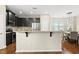 Kitchen features stainless steel appliances, breakfast bar, granite countertops, and black cabinets at 817 Ember Dr, Durham, NC 27703