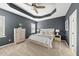 Spacious main bedroom boasts tray ceilings, neutral color palette, a ceiling fan, and carpet flooring at 817 Ember Dr, Durham, NC 27703