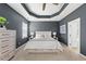 Tastefully decorated main bedroom features tray ceilings, soft carpet, and a modern style at 817 Ember Dr, Durham, NC 27703