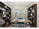Bright office with a window, built-in bookshelves, and a wooden desk at 817 Ember Dr, Durham, NC 27703