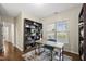 Home office with hardwood floors, built-in shelving and a desk at 817 Ember Dr, Durham, NC 27703