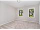 Bright bedroom with two windows and plush carpeting at 8512 Erinsbrook Dr, Raleigh, NC 27617