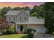 Charming two-story home boasts a well-maintained lawn, attached garage, and beautiful landscaping at 8512 Erinsbrook Dr, Raleigh, NC 27617